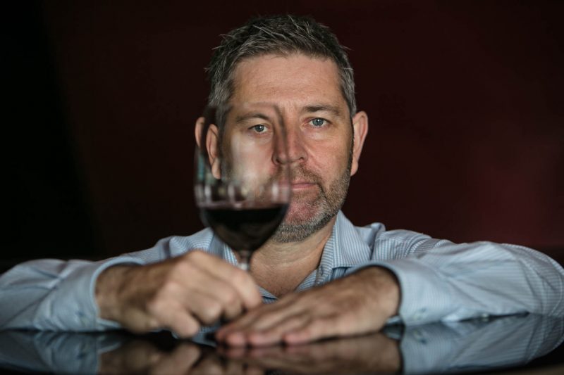 sommelier head shot with glass of wine