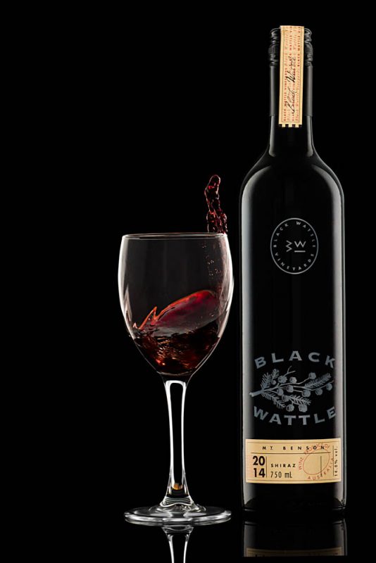 product photography of shiraz wine bottle and red wine glass