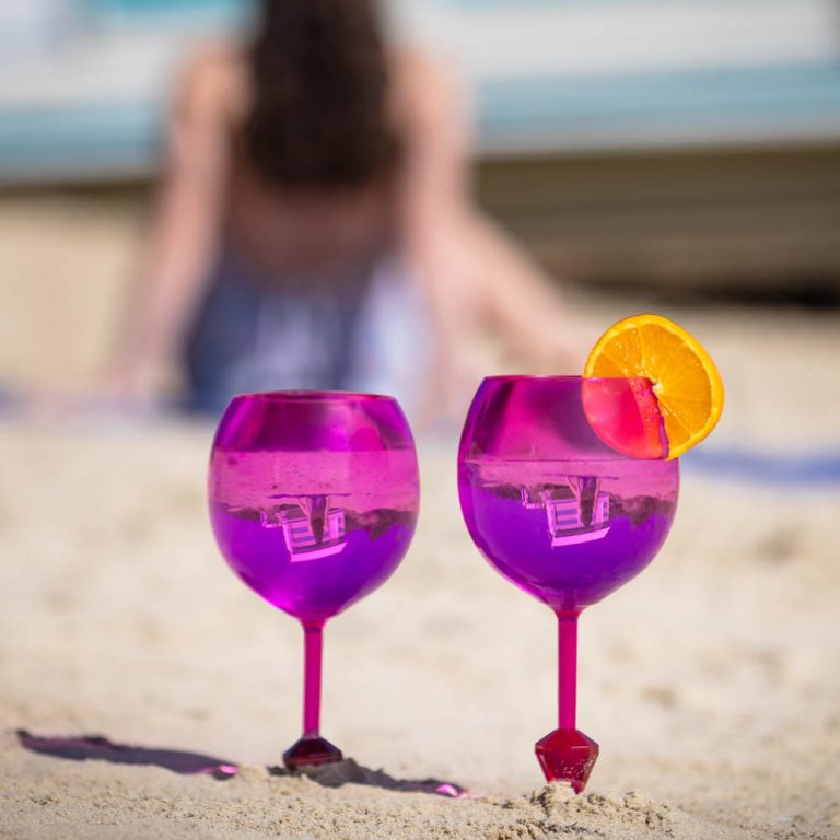 lifestyle example of Ecommerce Product Photography with 2 pink wine glasses in on beach Melbourne